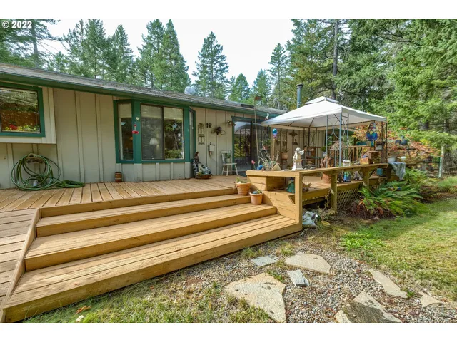 a backyard of a house with barbeque oven table and chairs