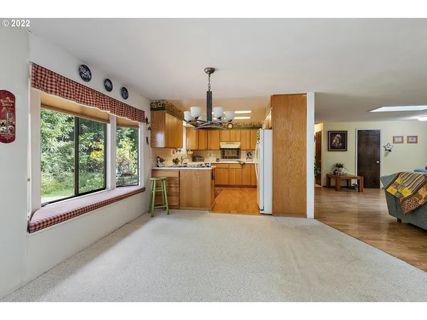 a kitchen that has a lot of windows and refrigerator