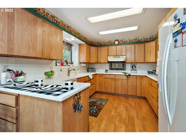 a kitchen with kitchen island granite countertop a sink cabinets and window