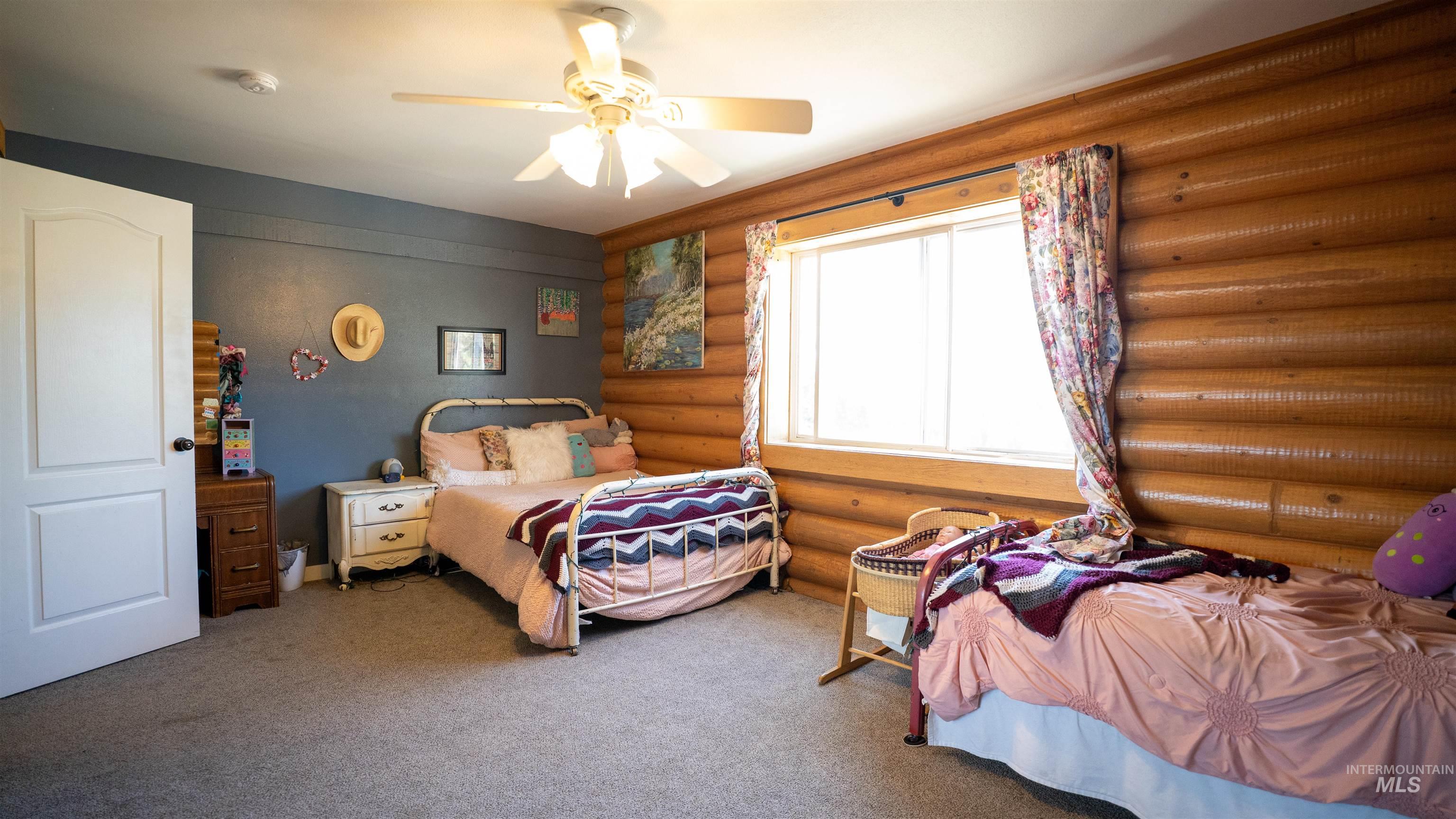 1321 Gold Hill Road Princeton, ID 83857 - Photo 12 of 29 Wood-paneled wall featuring two bunk beds with a third bunk bed visible