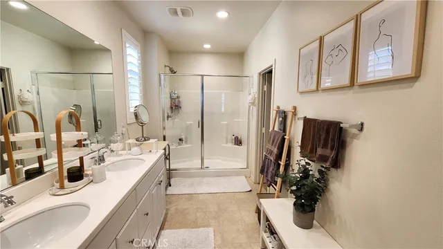 a bathroom with double vanity sink and mirror