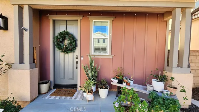 a front view of a house with potted plants