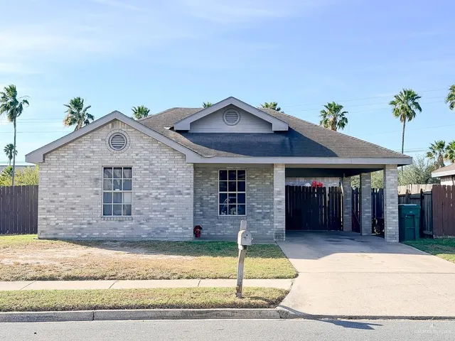a front view of a house with a garden and garage