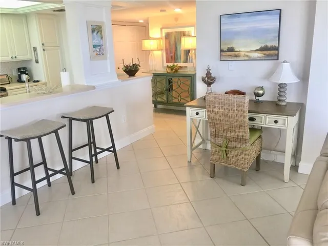 a dining room with furniture and a view of kitchen