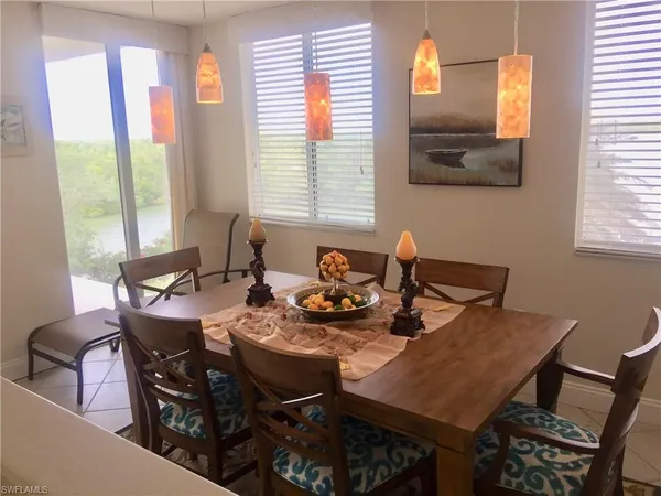 a view of a dining room with furniture and a window