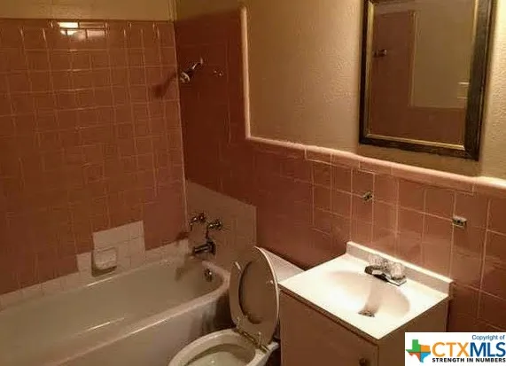 a bathroom with a bathtub and sink