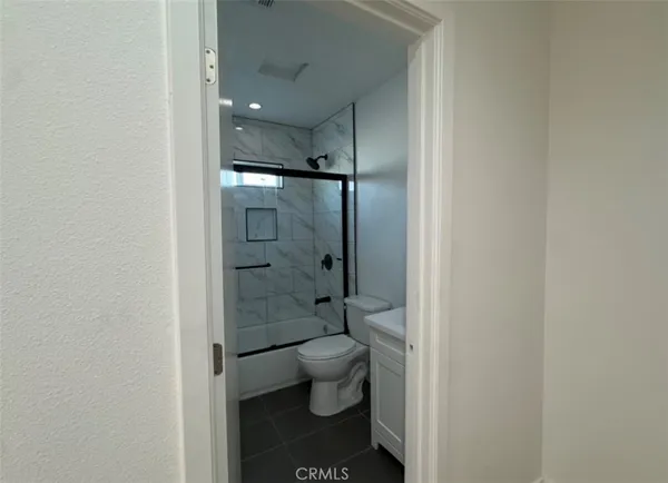 an empty room with wooden floor and closet