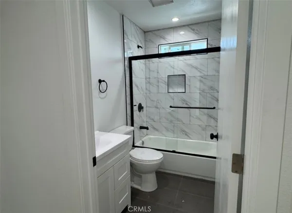a kitchen with a sink cabinets stainless steel appliances and a window