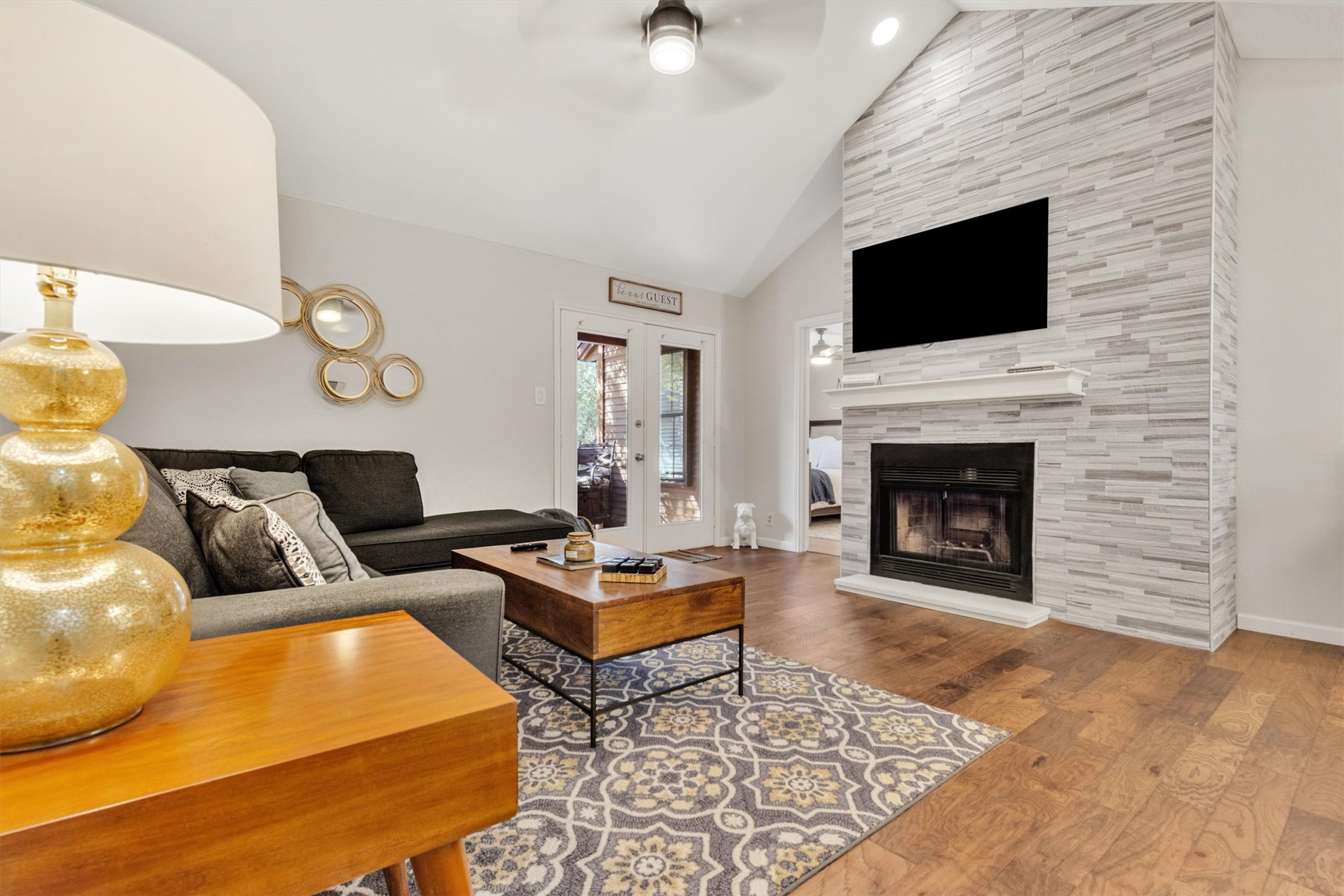 a living room with furniture flat screen tv and a fireplace