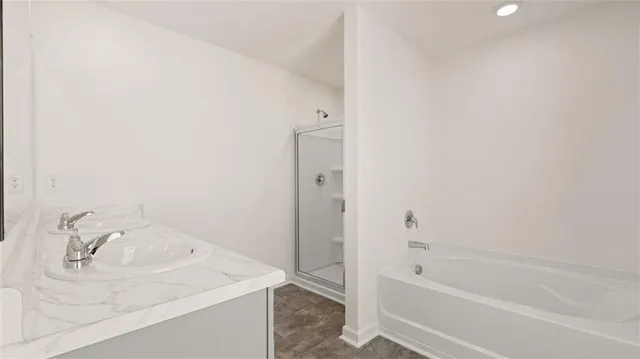 a bathroom with a tub sink vanity and a tub