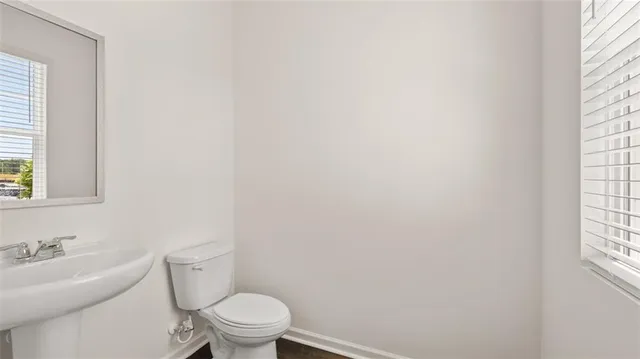 a white toilet sitting next to a bathroom sink