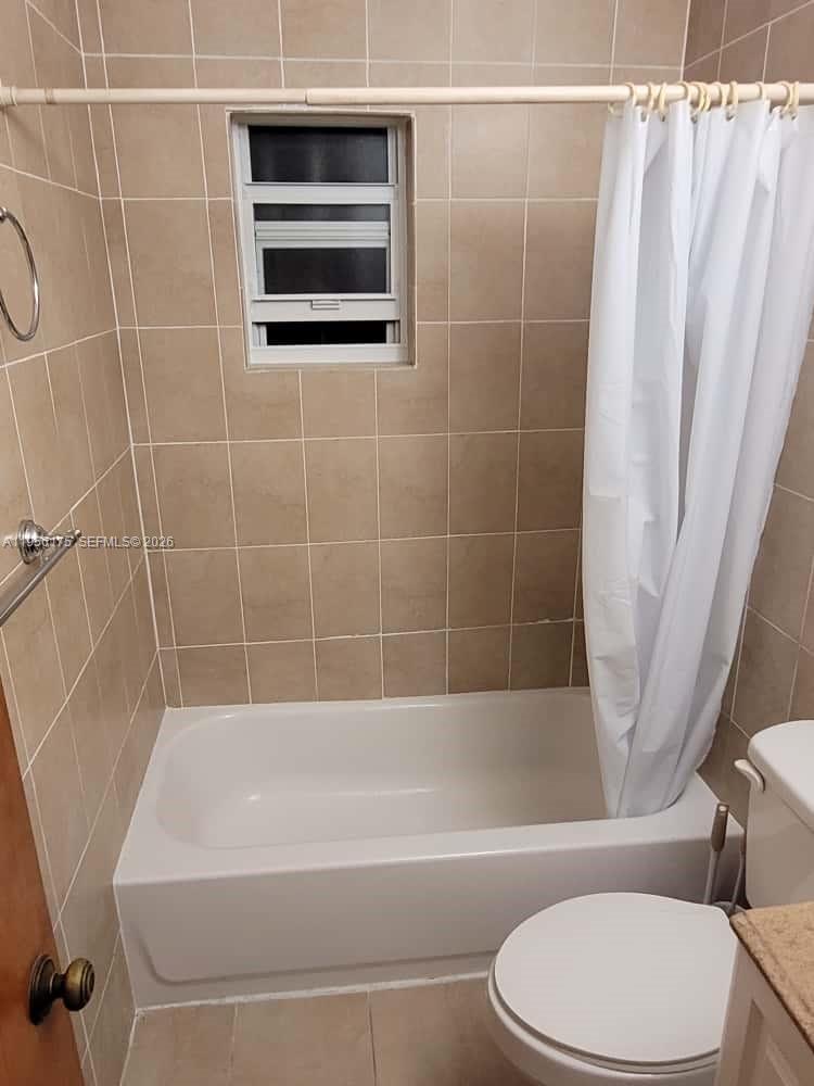 2828 Southwest 3rd Street, Unit FRONT Miami, FL 33135 - Photo 7 of 8 a bathroom with a toilet a sink and bathtub