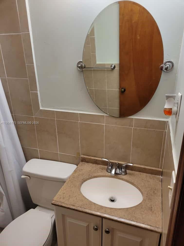 2828 Southwest 3rd Street, Unit FRONT Miami, FL 33135 - Photo 8 of 8 a bathroom with a sink and a mirror