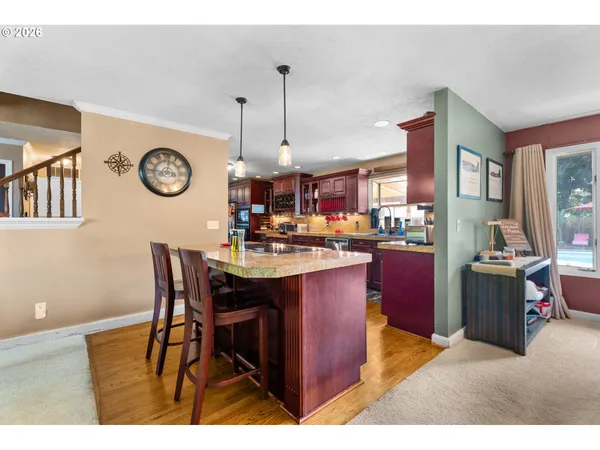 a kitchen with a dining table and chairs