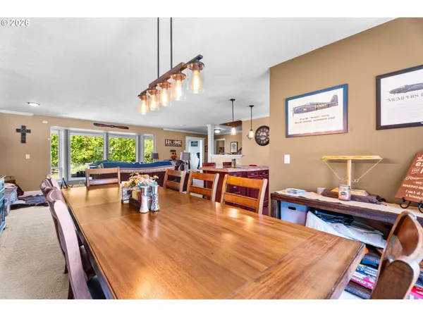 a living room with furniture a fireplace and a large window