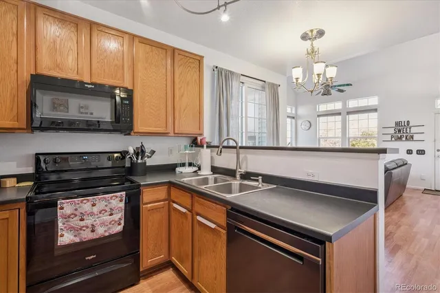 a kitchen with stainless steel appliances a stove sink microwave and cabinets