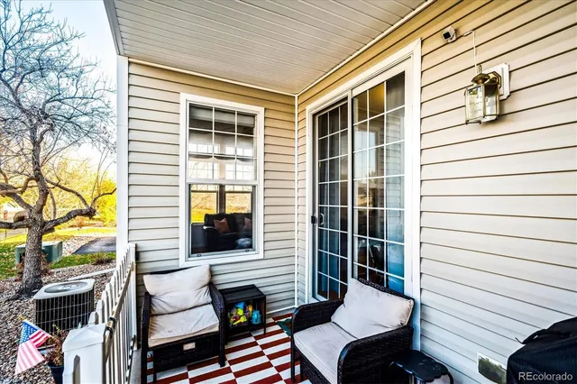 a view of a patio with a table and chairs and potted plants