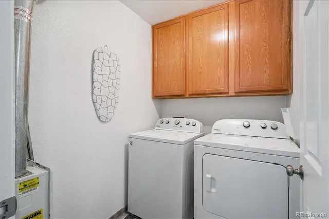 a view of storage and utility room with washer and dryer