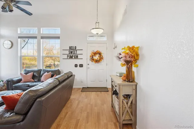a living room with furniture and a chandelier