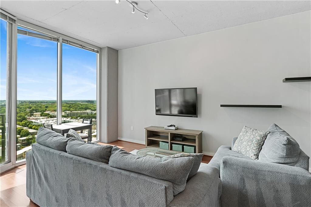 361 17th Street Northwest, Unit 2115 Atlanta, GA 30363 - Photo 1 of 24 a living room with furniture and a flat screen tv