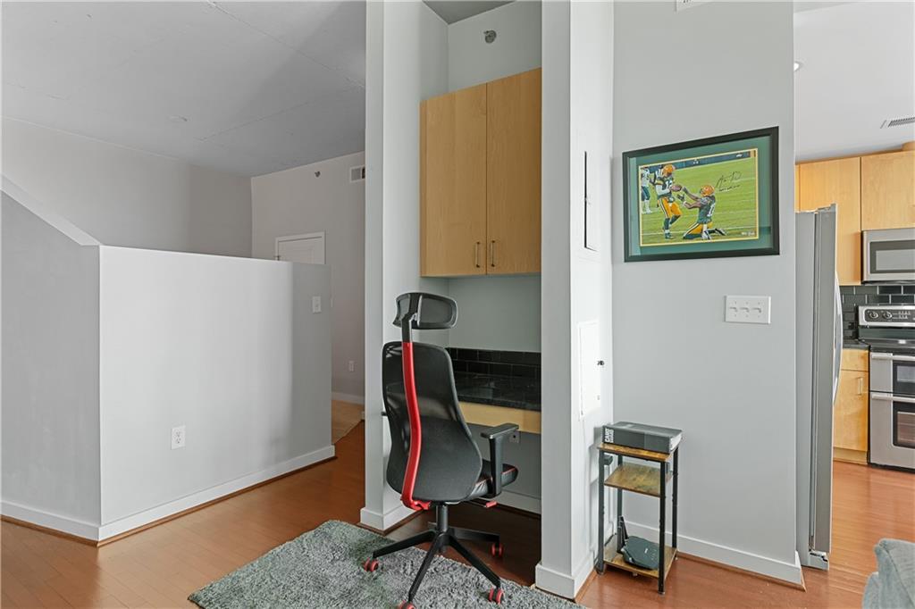 361 17th Street Northwest, Unit 2115 Atlanta, GA 30363 - Photo 12 of 24 a view of a workspace with furniture and wooden floor