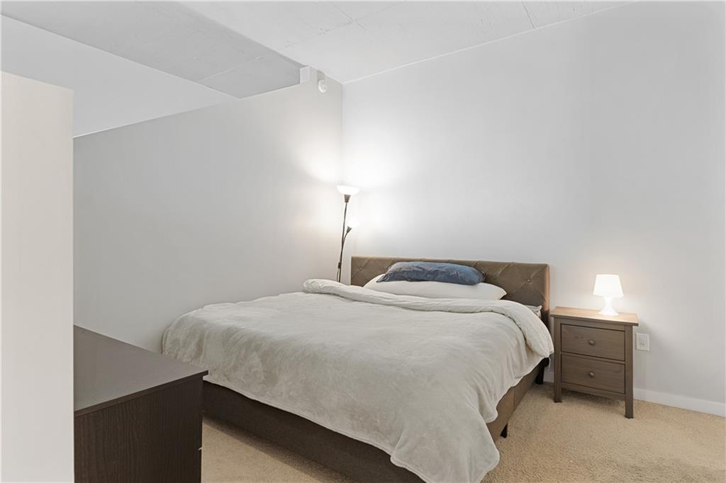 361 17th Street Northwest, Unit 2115 Atlanta, GA 30363 - Photo 13 of 24 a bedroom with a bed and a lamp