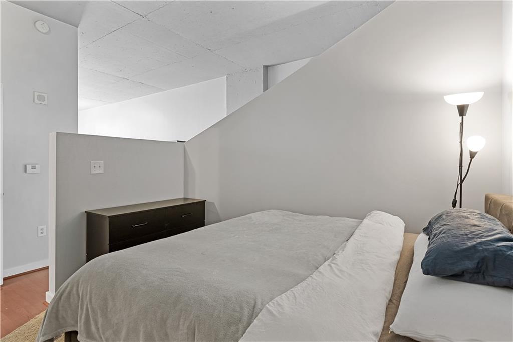 361 17th Street Northwest, Unit 2115 Atlanta, GA 30363 - Photo 14 of 24 a bedroom with a bed and a lamp