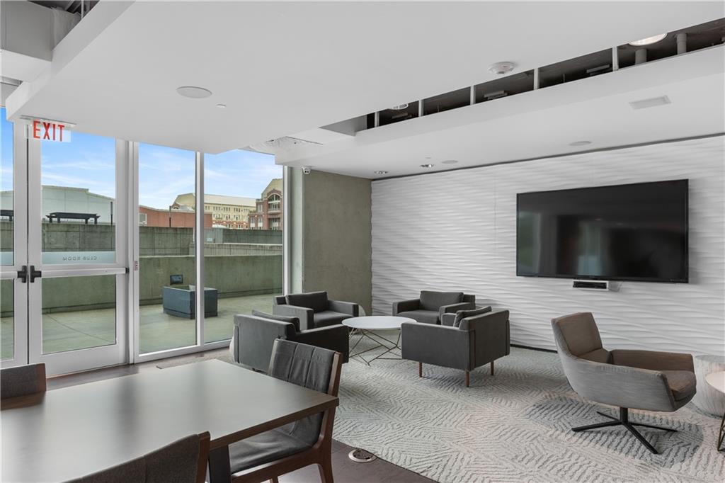 361 17th Street Northwest, Unit 2115 Atlanta, GA 30363 - Photo 22 of 24 a view of a livingroom with workspace and a window