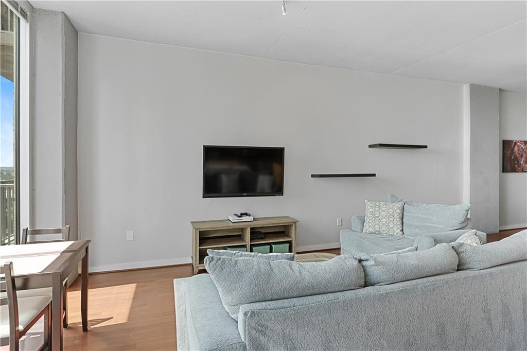 361 17th Street Northwest, Unit 2115 Atlanta, GA 30363 - Photo 3 of 24 a living room with furniture and a flat screen tv
