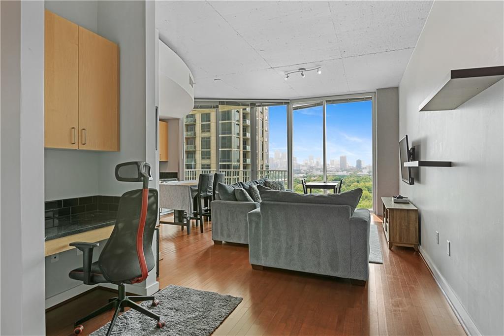 361 17th Street Northwest, Unit 2115 Atlanta, GA 30363 - Photo 4 of 24 a living room with furniture a wooden floor and a window