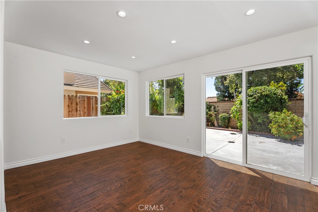 30 Entrada West Irvine, CA 92620 - Photo 17 of 41 a view of an empty room with wooden floor and windows