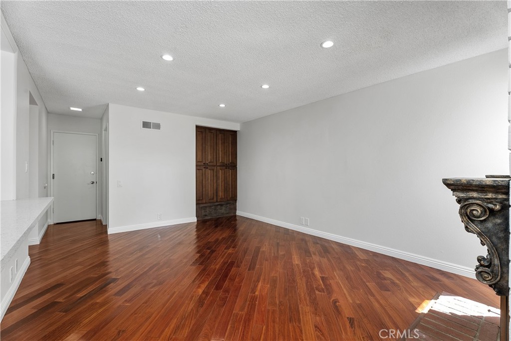 30 Entrada West Irvine, CA 92620 - Photo 19 of 41 a view of an empty room with wooden floor