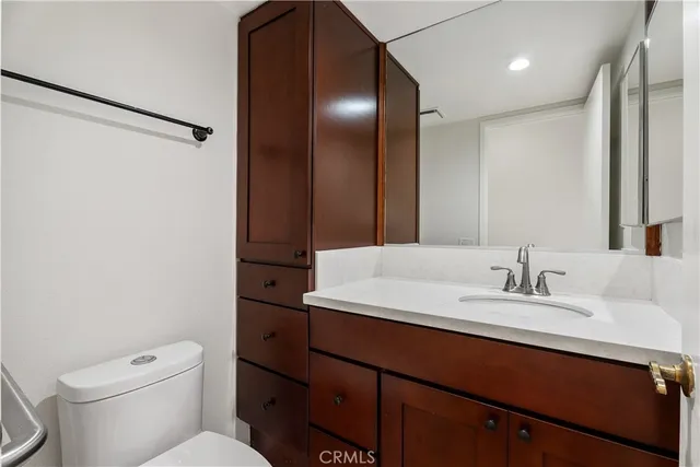 a bathroom with a sink a toilet and mirror