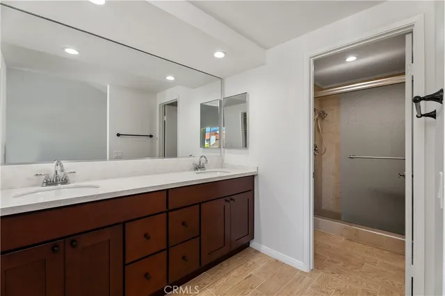 a bathroom with a double vanity sink and a mirror