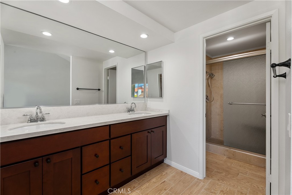 30 Entrada West Irvine, CA 92620 - Photo 25 of 41 a bathroom with a double vanity sink and a mirror