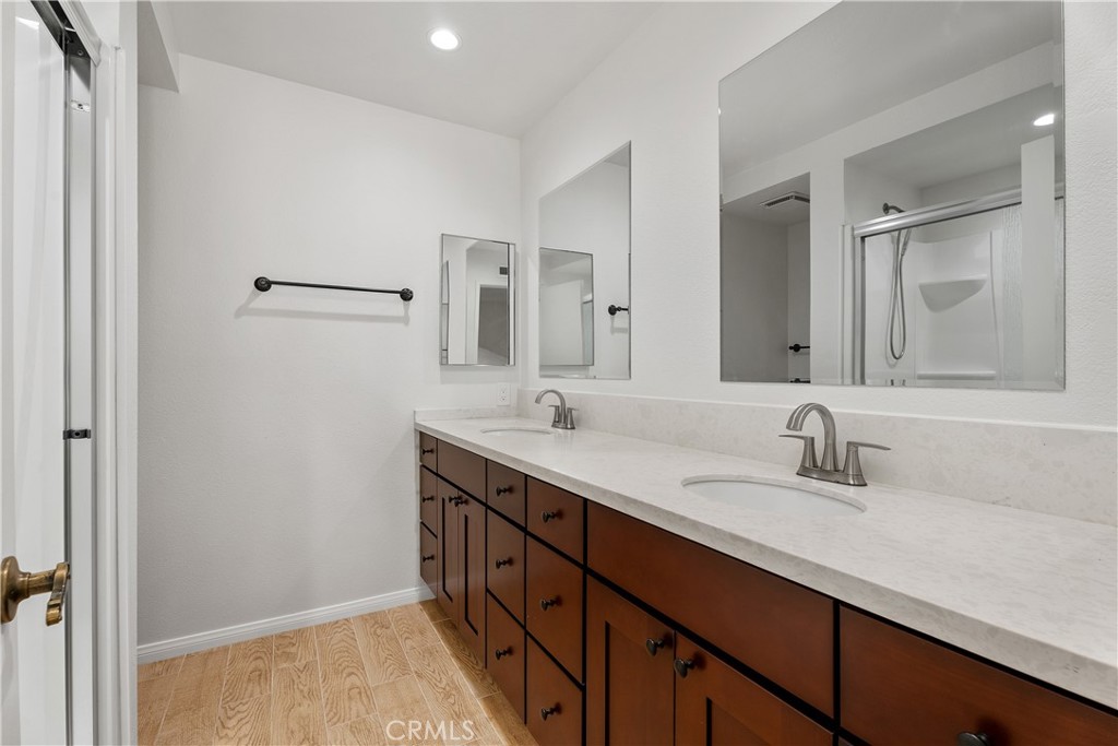 30 Entrada West Irvine, CA 92620 - Photo 32 of 41 a bathroom with a double vanity sink and mirror