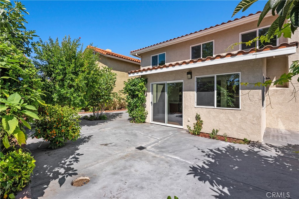30 Entrada West Irvine, CA 92620 - Photo 36 of 41 a front view of a house with a yard and potted plants