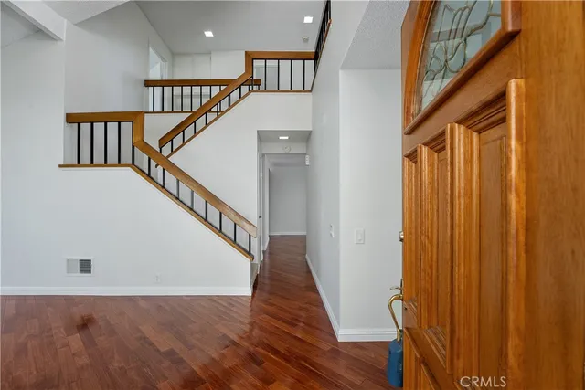 a view of entryway and hall with wooden floor