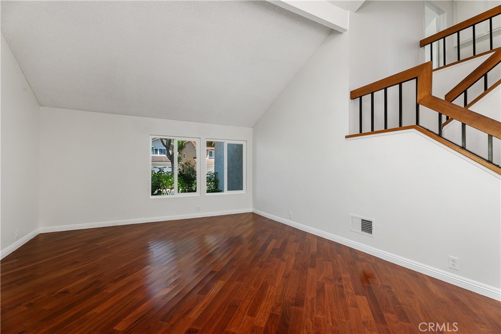 30 Entrada West Irvine, CA 92620 - Photo 7 of 41 a view of an empty room with wooden floor