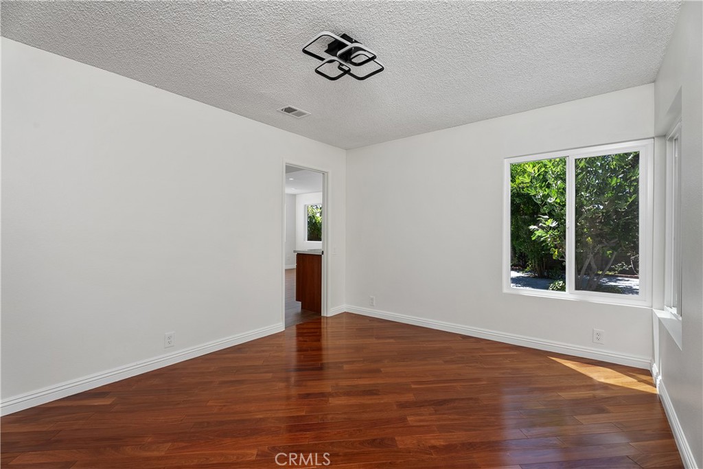 30 Entrada West Irvine, CA 92620 - Photo 10 of 41 a view of an empty room with wooden floor and a window