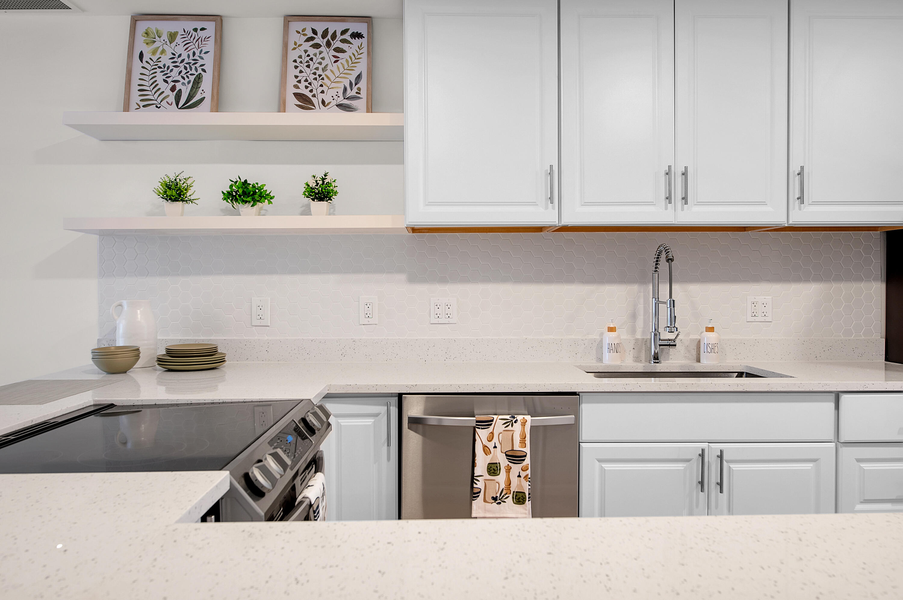 8799 Bella Vista Drive, Unit 2780 Boca Raton, FL 33433 - Photo 25 of 59 a kitchen with a white cabinets sink and dishwasher