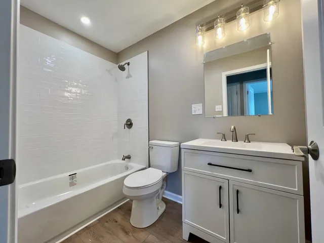 a bathroom with a sink toilet and shower