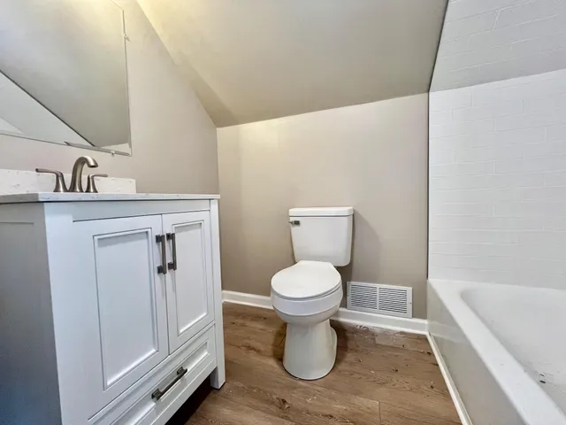 a bathroom with a toilet a sink and bathtub