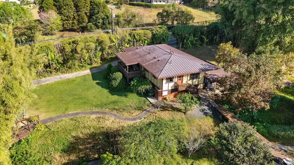 a view of house with garden space and trees