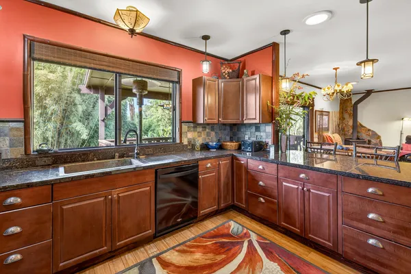 a kitchen with stainless steel appliances granite countertop sink stove and cabinets