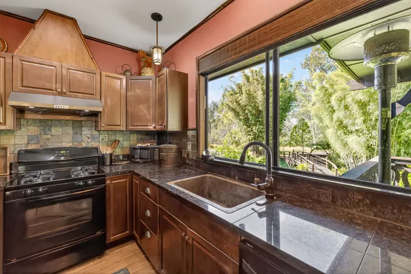a kitchen that has a sink and a stove