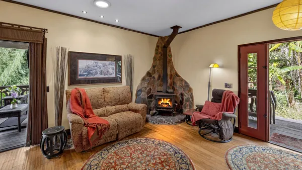 a living room with furniture a rug and a large window