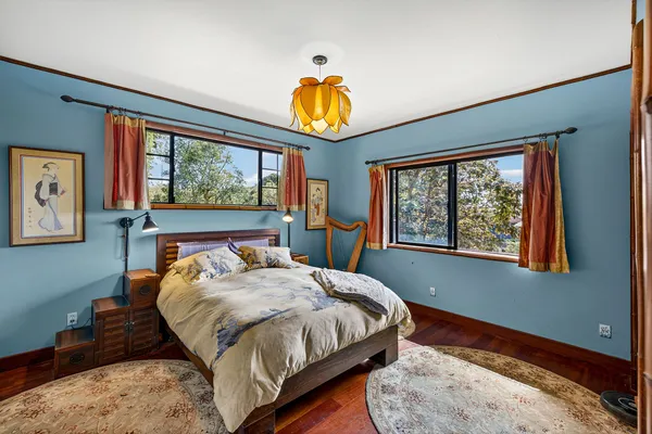 a bedroom with a bed and windows