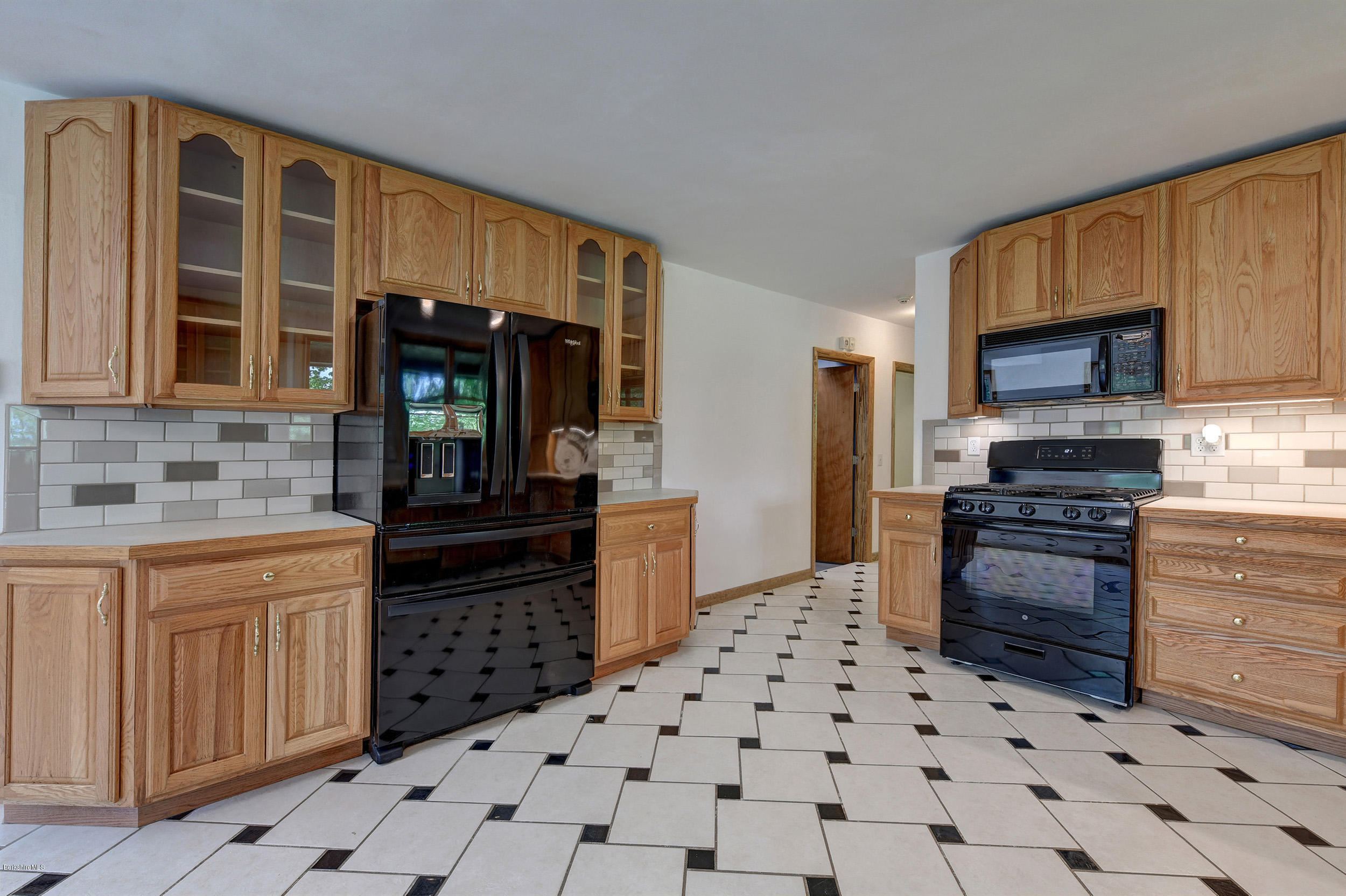 5 N Road Peru, MA 01235 - Photo 11 of 43 a kitchen with stainless steel appliances a stove a sink and a microwave