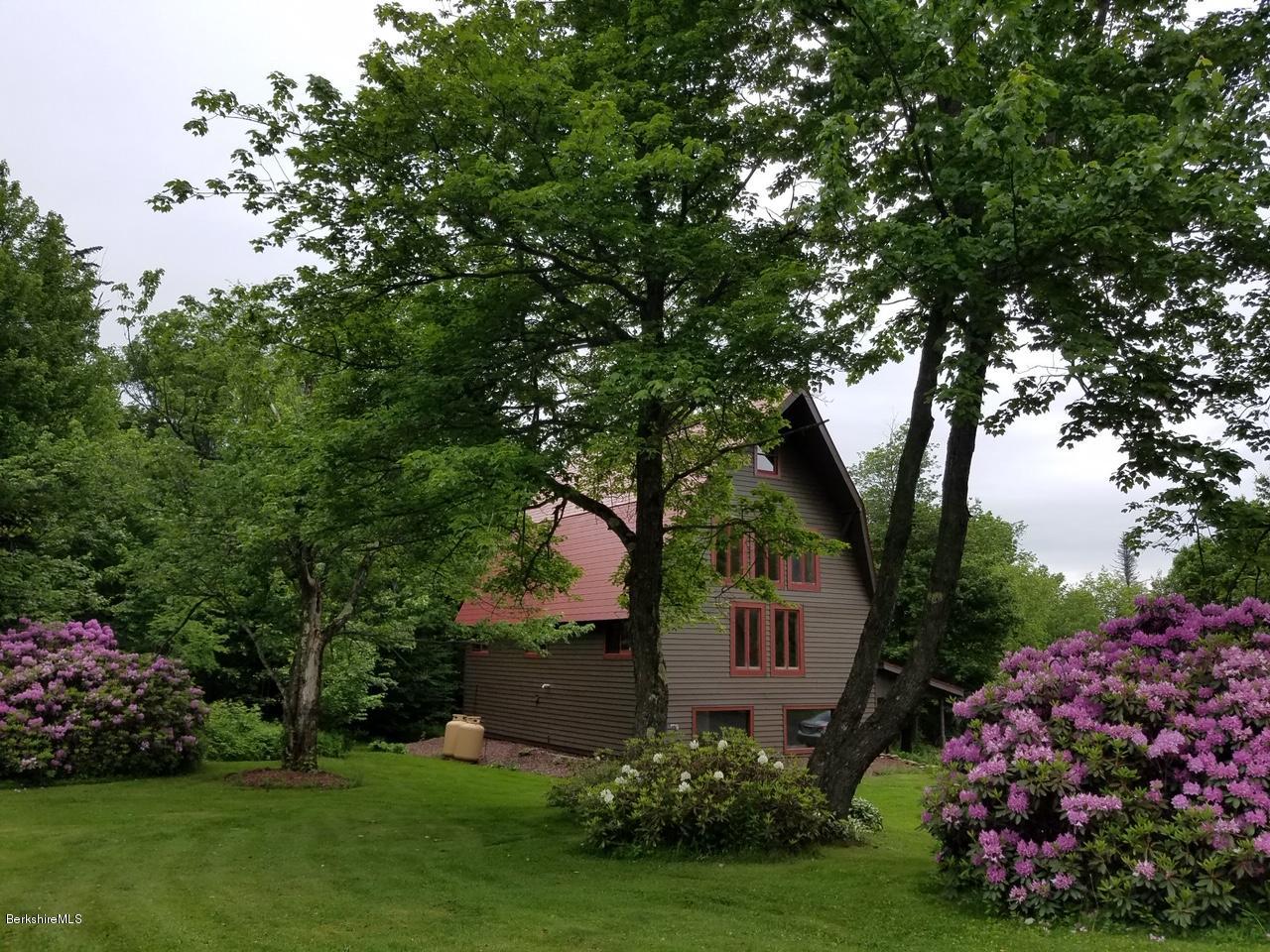 5 N Road Peru, MA 01235 - Photo 36 of 43 a front view of a house with a garden and trees